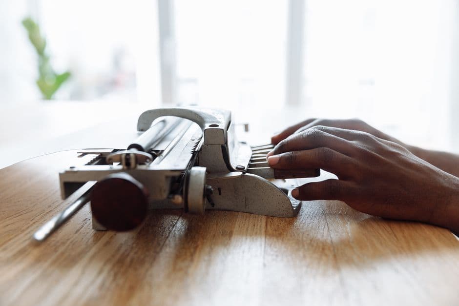 A man writing on a braille typewriter